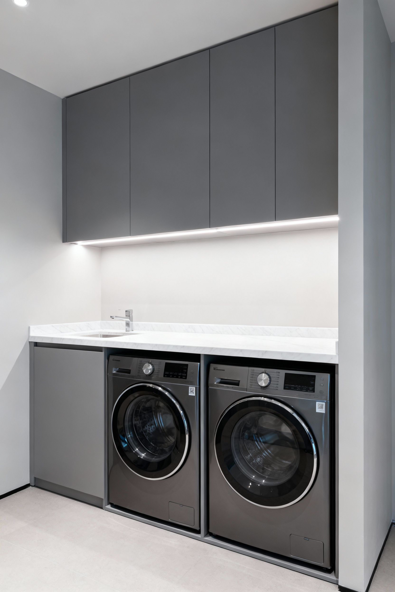 High-end laundry room with concealed washing machine and dryer integrated into custom, seamless modern cabinetry, enhancing architectural flow.